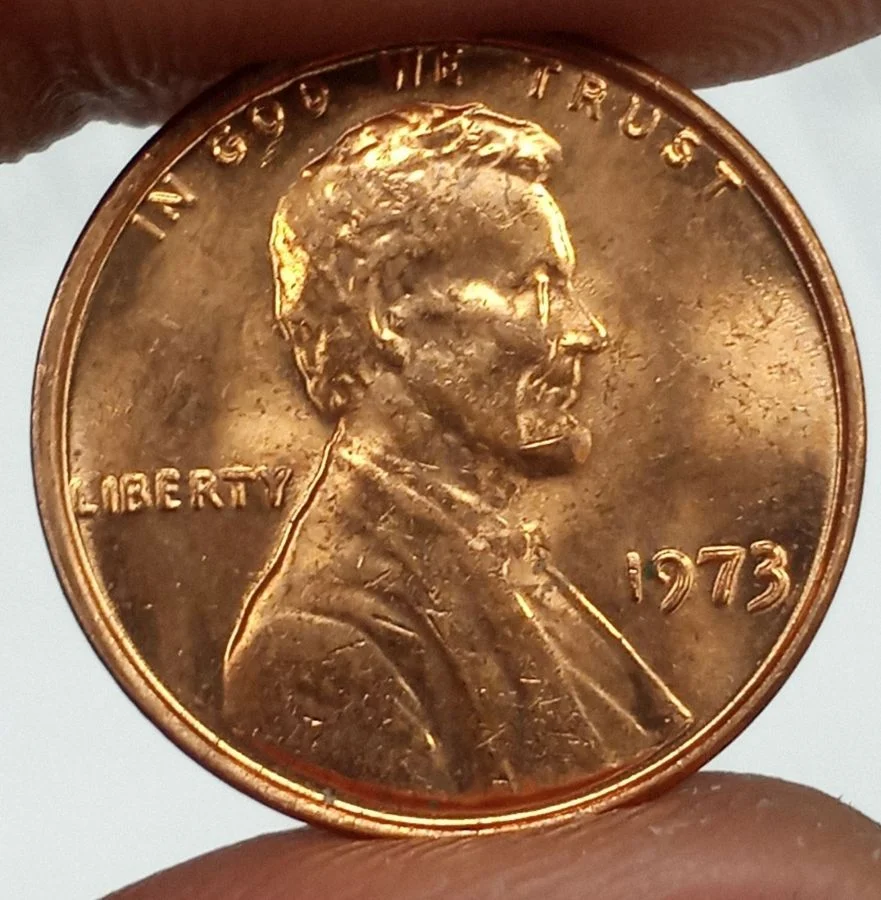 1973 Lincoln penny Doubled Die Obverse error close-up showing secondary doubled impression on LIBERTY or date with distinct separation between primary and doubled elements