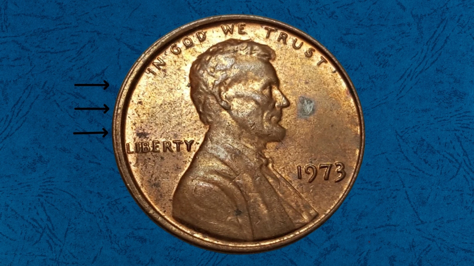 1973 Lincoln penny off-center strike error showing partial Lincoln portrait design with blank copper planchet arc and date still visible